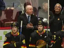 Canucks head coach Bruce Boudreau applauds the announcement of Quinn Hughes passing Doug Lidster as the all-time point leader for Canucks defensemen in April 2022.