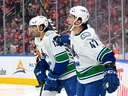 Paul Cotter #47 and Arshdeep Bains #13 celebrate Cotter's first period goal against the Oilers