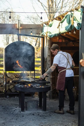 Chef-owner Joel Gray cooks over an open fire at Down Home, a restaurant in the Ontario countryside where dining is also an experience.