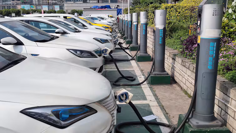 Electric vehicles at charging stations in China.