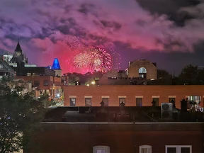 Red fireworks at the Library of Parliament building.
