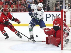 Pyotr Kochetkov of the Carolina Hurricanes saves a shot attempt by Paul Cotter of the Vancouver Canucks in the second period