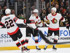 Michael Amadio, Tim Stutzle, center, and Nikolas Matinpalo of the Ottawa Senators celebrate Stutzle's first period goal against the Boston Bruins Monday, Oct. 5, 2026, at TD Garden in Boston.
